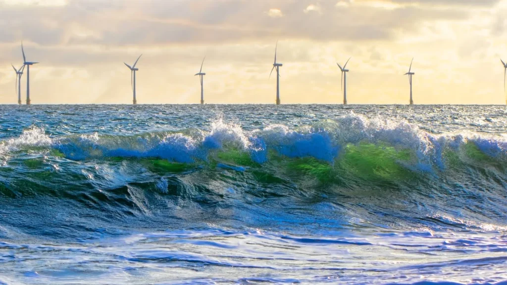 Sea ​​windmills with waves in the foreground